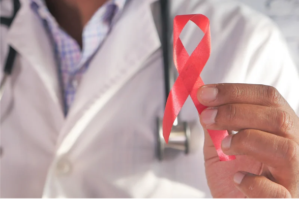 doctor holding red HIV ribbon