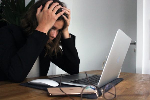 woman frustrated looking at a laptop